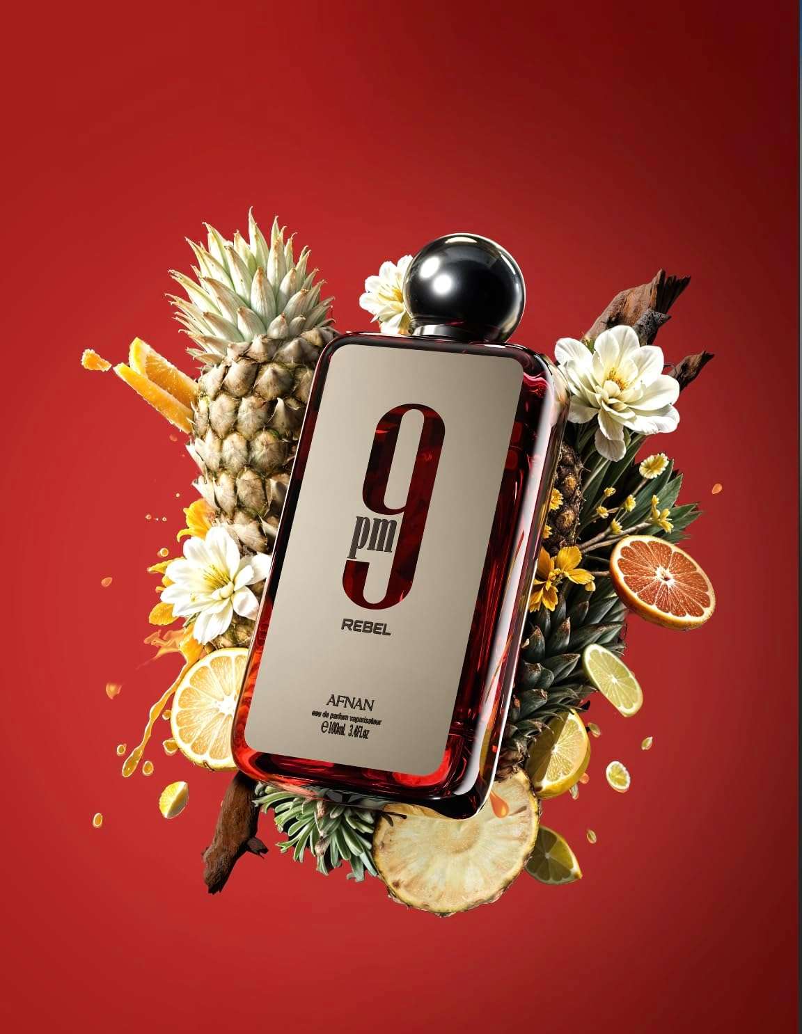 Afnan 9 PM Rebel perfume bottle surrounded by tropical fruits and flowers on red background Afnan 9 PM Rebel perfume bottle surrounded by tropical fruits and flowers on red background