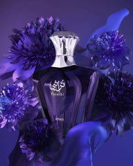 Afnan Turathi Blue perfume for men bottle surrounded by purple flowers with a silver cap Afnan Turathi Blue perfume for men bottle surrounded by purple flowers with a silver cap