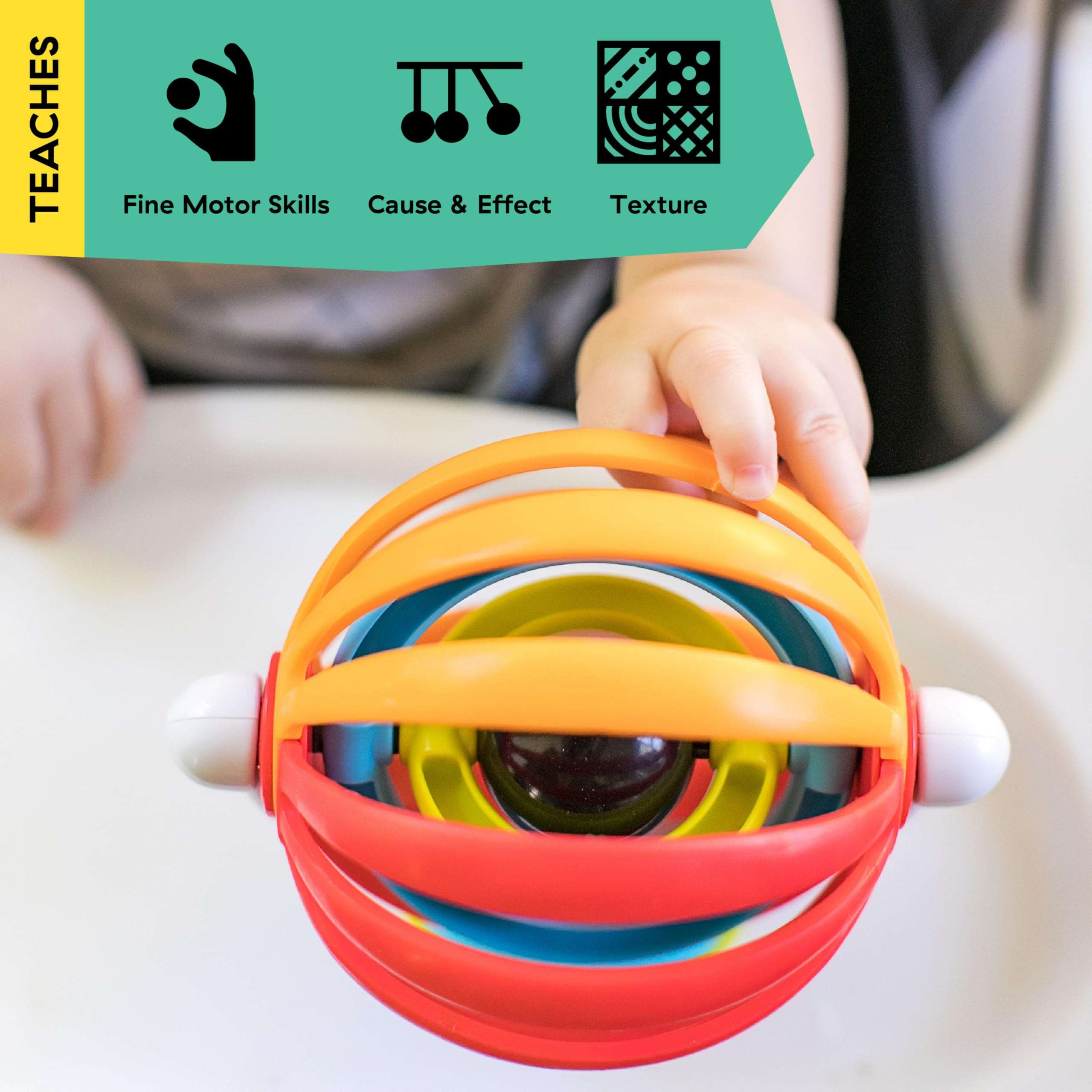 Ba Einstein baby high chair activity toy colorful nesting ring spinner with mirror held by babys hand on tray Ba Einstein baby high chair activity toy colorful nesting ring spinner with mirror held by babys hand on tray