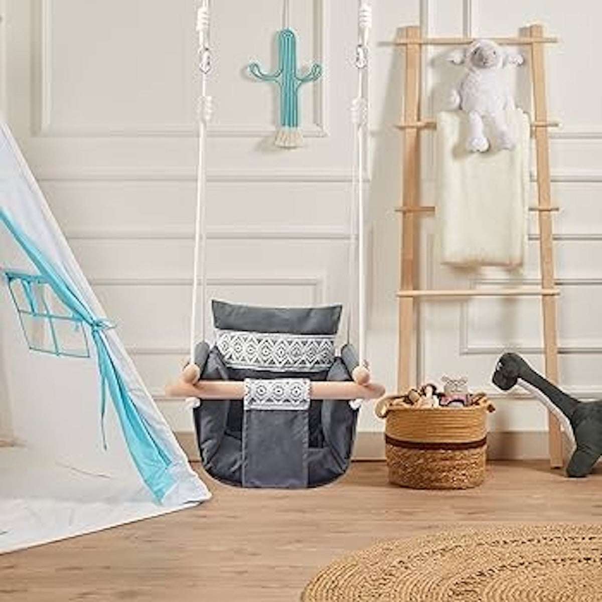 Cozy baby fabric swing with wooden frame hanging in a stylish playroom setting Cozy baby fabric swing with wooden frame hanging in a stylish playroom setting