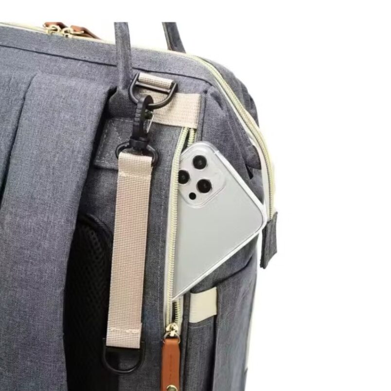 Huitich baby travel backpack diaper bag in gray with side pocket holding a smartphone Huitich baby travel backpack diaper bag in gray with side pocket holding a smartphone