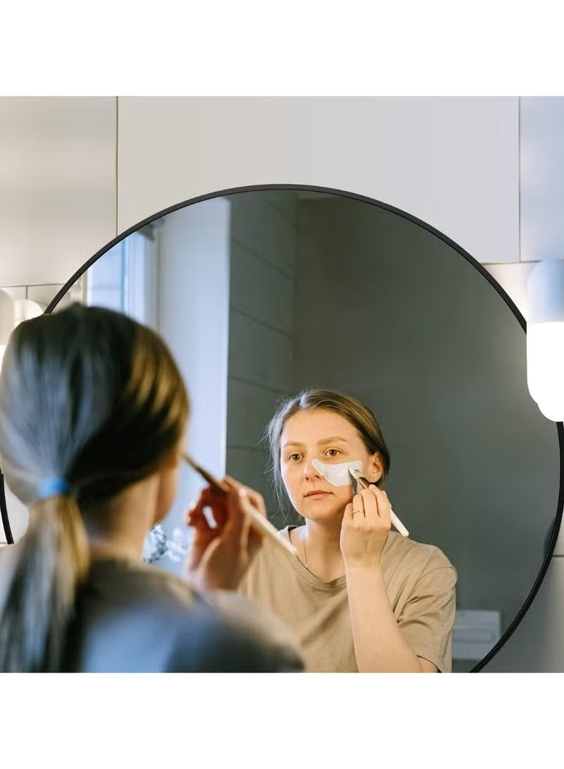 Huitich black round wall mirror with lights mounted on bathroom wall with woman applying makeup Huitich black round wall mirror with lights mounted on bathroom wall with woman applying makeup