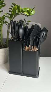 Huitich black silicone kitchen utensils set with knife in a black stand on white table Huitich black silicone kitchen utensils set with knife in a black stand on white table