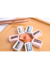 Huitich mini pencil sharpener set with pastel colors arranged on wooden tray with pencil shavings Huitich mini pencil sharpener set with pastel colors arranged on wooden tray with pencil shavings