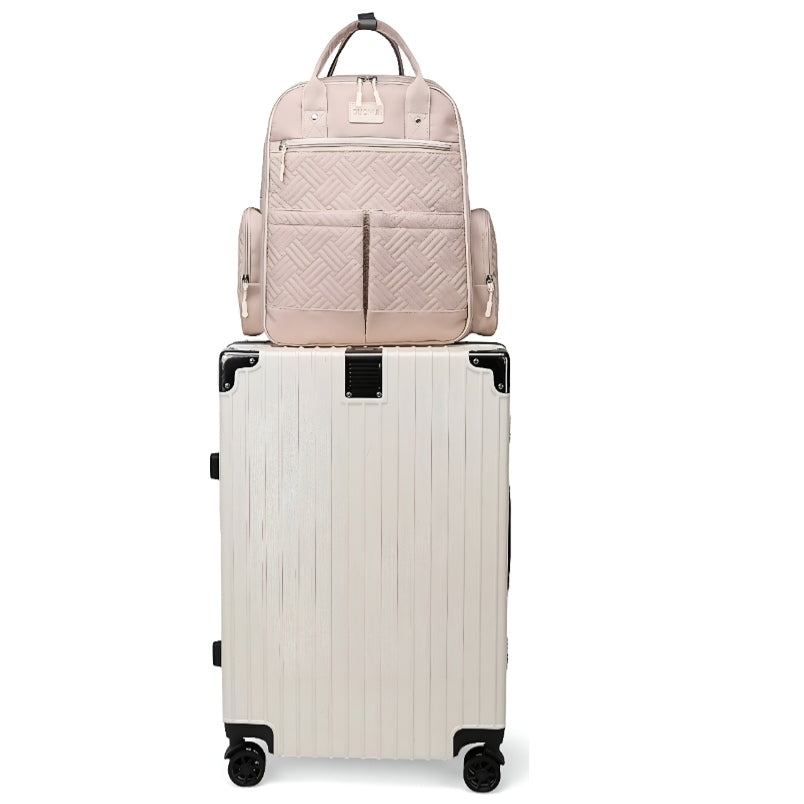 Huitich stylish baby travel bag in blush pink quilted design sitting on top of white rolling suitcase Huitich stylish baby travel bag in blush pink quilted design sitting on top of white rolling suitcase