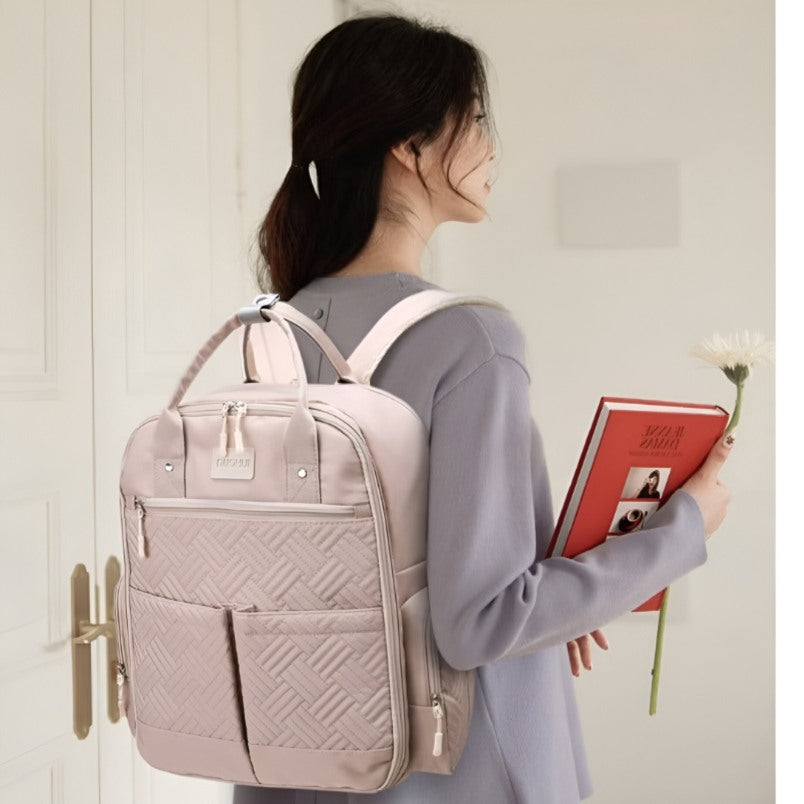 Huitich stylish baby travel bag backpack in light pink with multiple pockets worn by woman Huitich stylish baby travel bag backpack in light pink with multiple pockets worn by woman