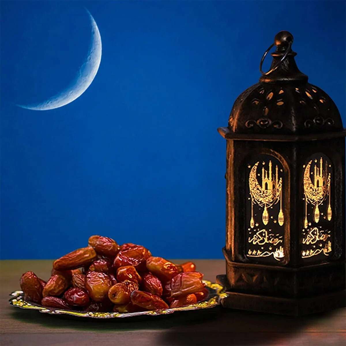 Huitich Ramadan LED lantern decoration with festive lantern light assorted colors beside a plate of dates under crescent moon Huitich Ramadan LED lantern decoration with festive lantern light assorted colors beside a plate of dates under crescent moon