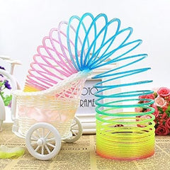 Huitich rainbow magic spring toy displayed next to a white decorative baby carriage on vintage paper Huitich rainbow magic spring toy displayed next to a white decorative baby carriage on vintage paper
