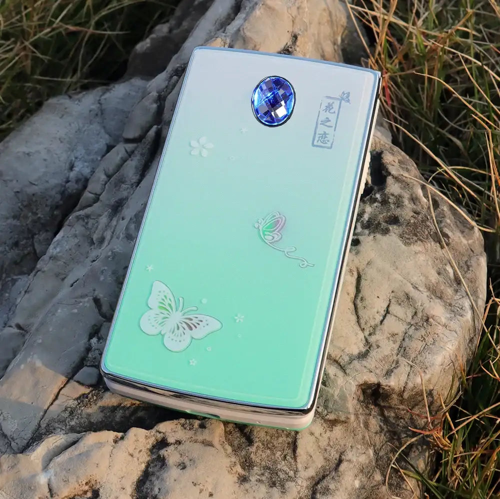 Mumzar mint green women flip phone dual sim with butterfly design and blue gem camera Mumzar mint green women flip phone dual sim with butterfly design and blue gem camera