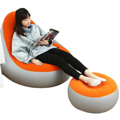 Huitich inflatable orange lounge chair with matching footrest and woman reading magazine Huitich inflatable orange lounge chair with matching footrest and woman reading magazine