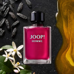 Joop Homme perfume for men 200ml bottle with black cap surrounded by flowers and spices Joop Homme perfume for men 200ml bottle with black cap surrounded by flowers and spices