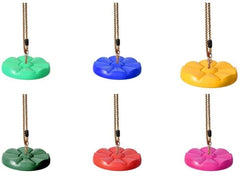 Colorful kids outdoor disc swing seat in green, blue, yellow, red arranged on ropes for outdoor play Colorful kids outdoor disc swing seat in green, blue, yellow, red arranged on ropes for outdoor play
