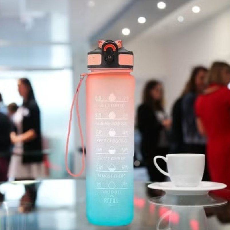 Huitich motivational water bottle 1 liter with gradient pink and blue design on table Huitich motivational water bottle 1 liter with gradient pink and blue design on table