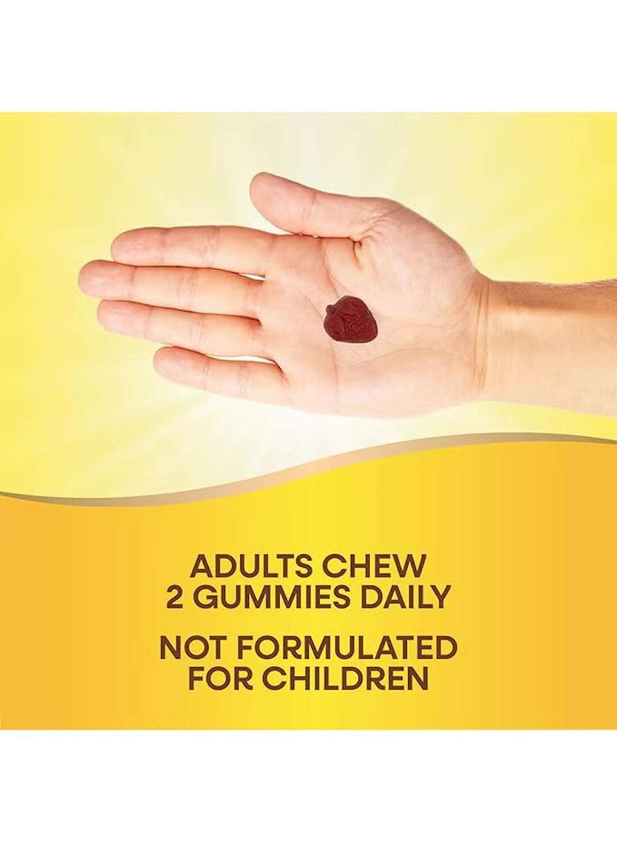 Nature's Way hair skin and nails gummies in a hand with a bright yellow background for adult health support Nature's Way hair skin and nails gummies in a hand with a bright yellow background for adult health support