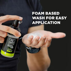 PEESAFE foam pump bottle dispensing natural intimate wash for men into hand on dark background PEESAFE foam pump bottle dispensing natural intimate wash for men into hand on dark background