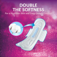 White absorbent sanitary pad with cotton insert and double softness text on pink background maxi night sanitary pads UAE White absorbent sanitary pad with cotton insert and double softness text on pink background maxi night sanitary pads UAE