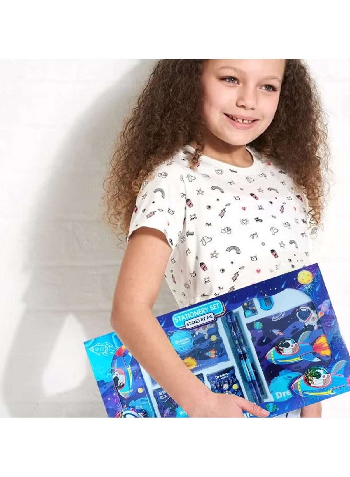Child holding a colorful Huitich space stationery set for kids featuring vibrant space-themed designs Child holding a colorful Huitich space stationery set for kids featuring vibrant space-themed designs