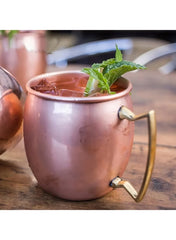 Huitich copper stainless steel beverage mug with brass handle filled with iced drink and mint garnish Huitich copper stainless steel beverage mug with brass handle filled with iced drink and mint garnish