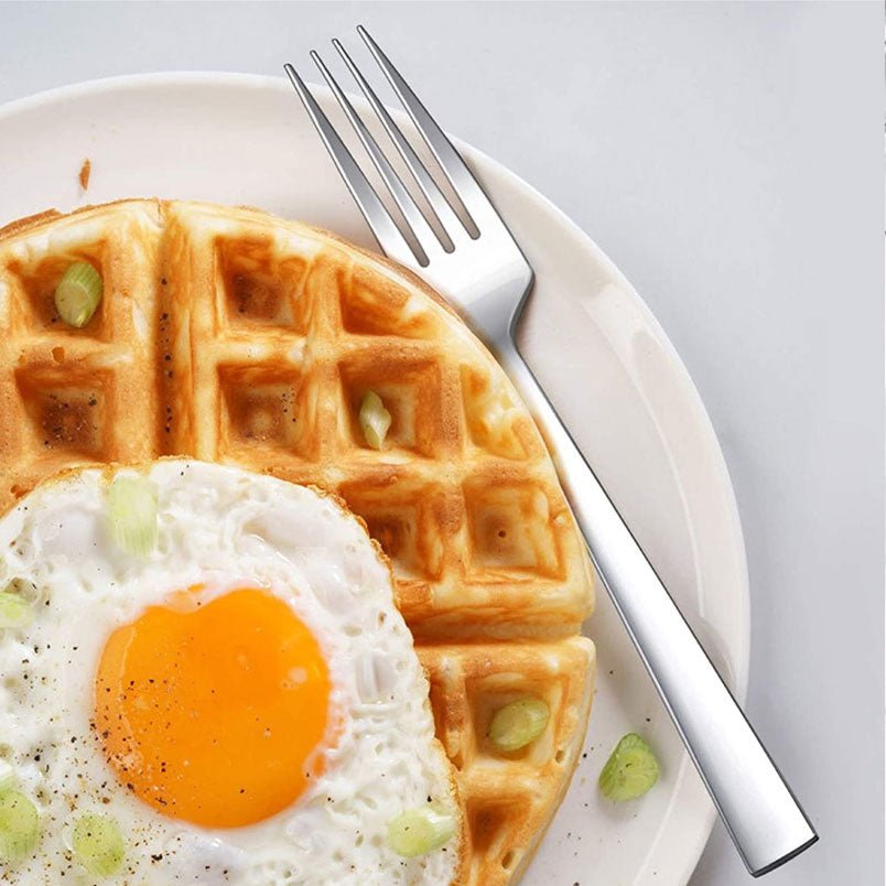 Huitich steel forks set of 12 for kitchen shown with a fork on a plate holding waffle and fried egg Huitich steel forks set of 12 for kitchen shown with a fork on a plate holding waffle and fried egg