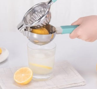 Huitich stainless steel lemon squeezer with blue handle pressing lemon over glass of lemonade Huitich stainless steel lemon squeezer with blue handle pressing lemon over glass of lemonade