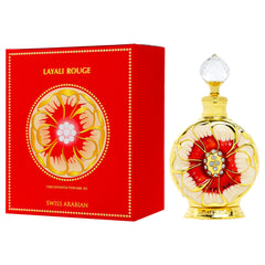 Swiss Arabian Layali Rouge perfume oil bottle with decorative gold and red floral design next to matching red box Swiss Arabian Layali Rouge perfume oil bottle with decorative gold and red floral design next to matching red box