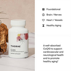 THORNE CoQ10 dietary supplement bottle on table with product info cards CoQ10 supplement for heart health THORNE CoQ10 dietary supplement bottle on table with product info cards CoQ10 supplement for heart health