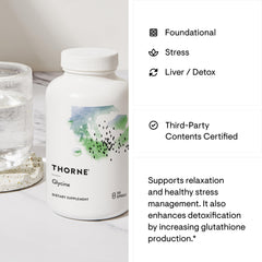 Thorne Glycine supplement for relaxation in white THORNE bottle on marble countertop with glass of water Thorne Glycine supplement for relaxation in white THORNE bottle on marble countertop with glass of water