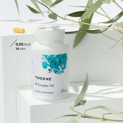 THORNE B Complex supplement bottle with yellow capsule and eucalyptus leaves Vitamin B Complex supplement UAE THORNE B Complex supplement bottle with yellow capsule and eucalyptus leaves Vitamin B Complex supplement UAE