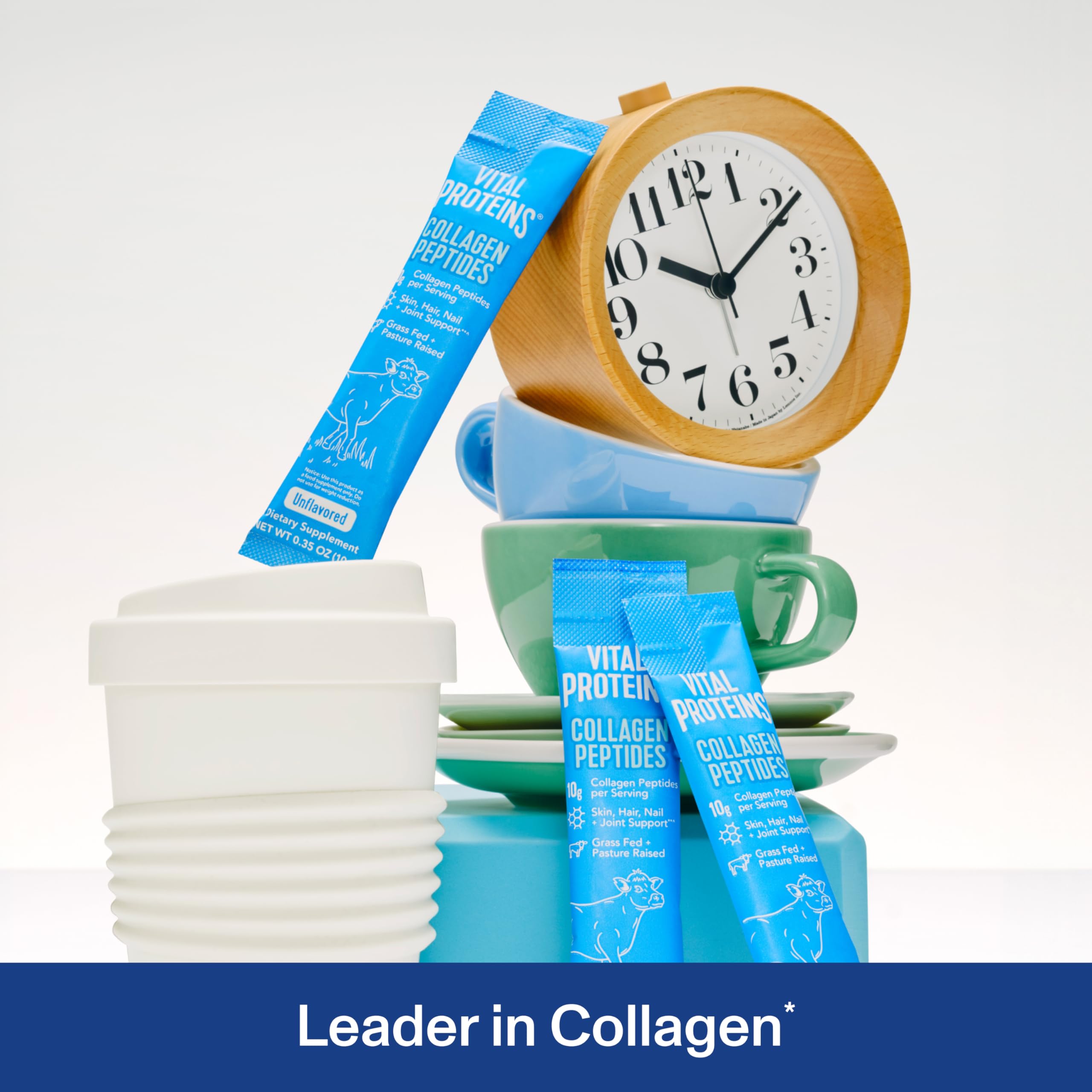 Vital Proteins blue single serve packets next to stacked cups and clock showing collagen peptides powder supplement Vital Proteins blue single serve packets next to stacked cups and clock showing collagen peptides powder supplement