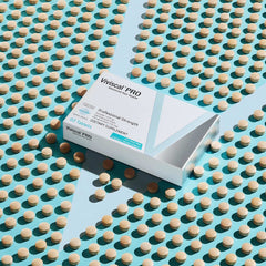 Box of Viviscal PRO hair growth supplements with 60 tablets on teal background surrounded by tablets Box of Viviscal PRO hair growth supplements with 60 tablets on teal background surrounded by tablets