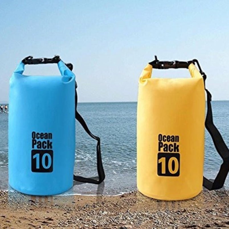Huitich waterproof sport shoulder bag in blue and yellow Ocean Pack 10 near the beach water Huitich waterproof sport shoulder bag in blue and yellow Ocean Pack 10 near the beach water