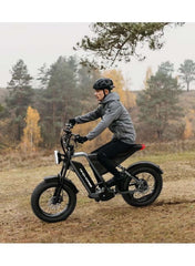WIND HORSE rider on black electric mountain bike 1000w UAE riding off road in autumn forest with fat tires WIND HORSE rider on black electric mountain bike 1000w UAE riding off road in autumn forest with fat tires
