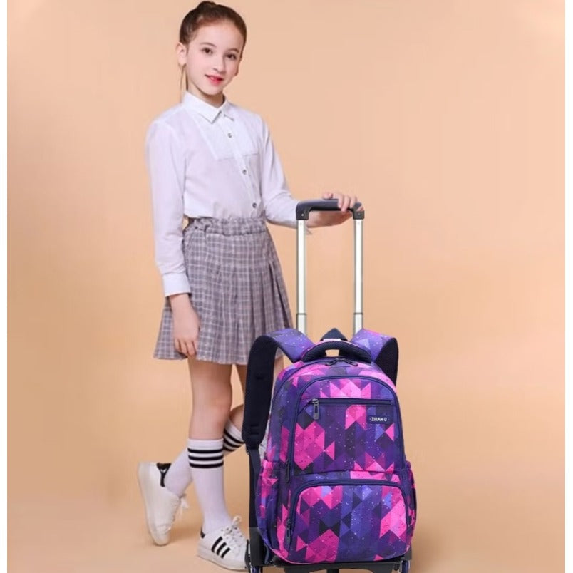 Girl holding a diamond pattern kids trolley backpack by Huitich in purple and pink geometric design Girl holding a diamond pattern kids trolley backpack by Huitich in purple and pink geometric design