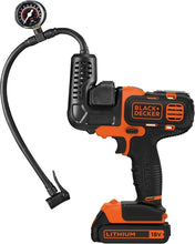 Inflator attachment on orange/black power tool with pressure gauge and hose