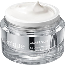 Clear glass skin cream jar with silver lid and white cream swirl