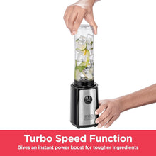 Hand placing clear blending jar onto black sports blender base