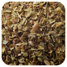 Close-up of dried oregano leaves, chopped and scattered