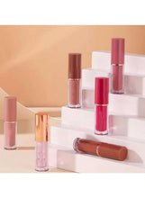 Lip gloss tubes and wands displayed on clear stepped stands