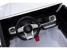 Kids ride-on car interior with steering wheel and dashboard controls