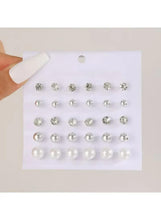 Crystal and pearl stud earrings set card held in hand, rows of round stone and pearl studs
