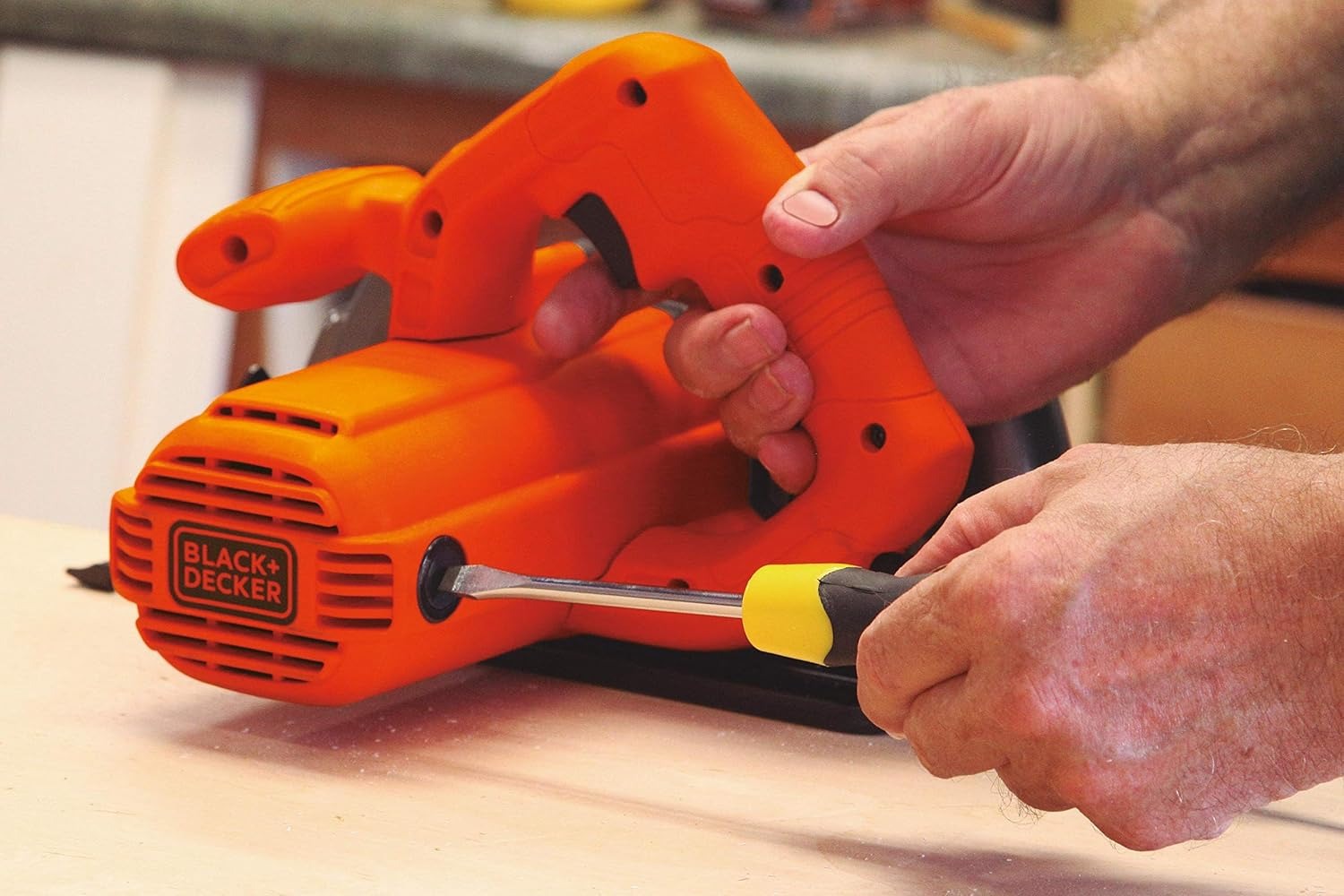 Black+Decker 1400W circular saw, orange body, exposed blade on wood