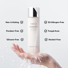 TIRTIR Milk Skin Toner on hand with clear droplets and bottle
