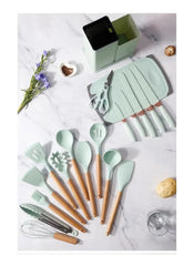 Huitich 19 piece kitchen tool set UAE with pastel green utensils and wooden handles on marble surface