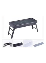 Portable charcoal grill with metal mesh grate and black folding-style legs