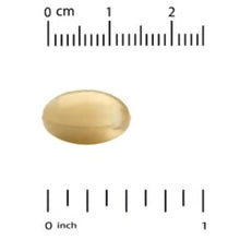 Biotin softgel capsule beside a ruler, marked near 1 inch