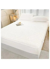 White fitted waterproof mattress topper on a bed with matching pillowcase