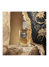 Eau de parfum bottle with gold liquid and silver cap, featuring heart emblem label