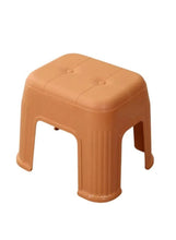 Orange plastic shoe stool with rounded top and four short legs
