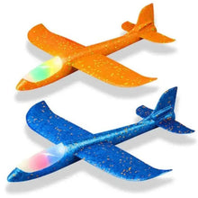 Light-up kids airplane gliders, orange and blue with glowing nose lights.