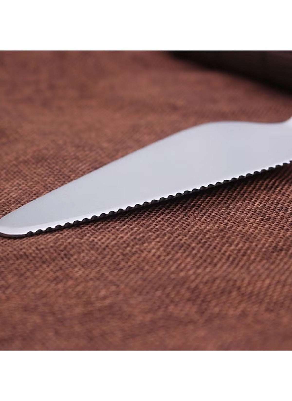 Huitich 2 piece cake serving utensils with serrated stainless steel knife blade on brown fabric